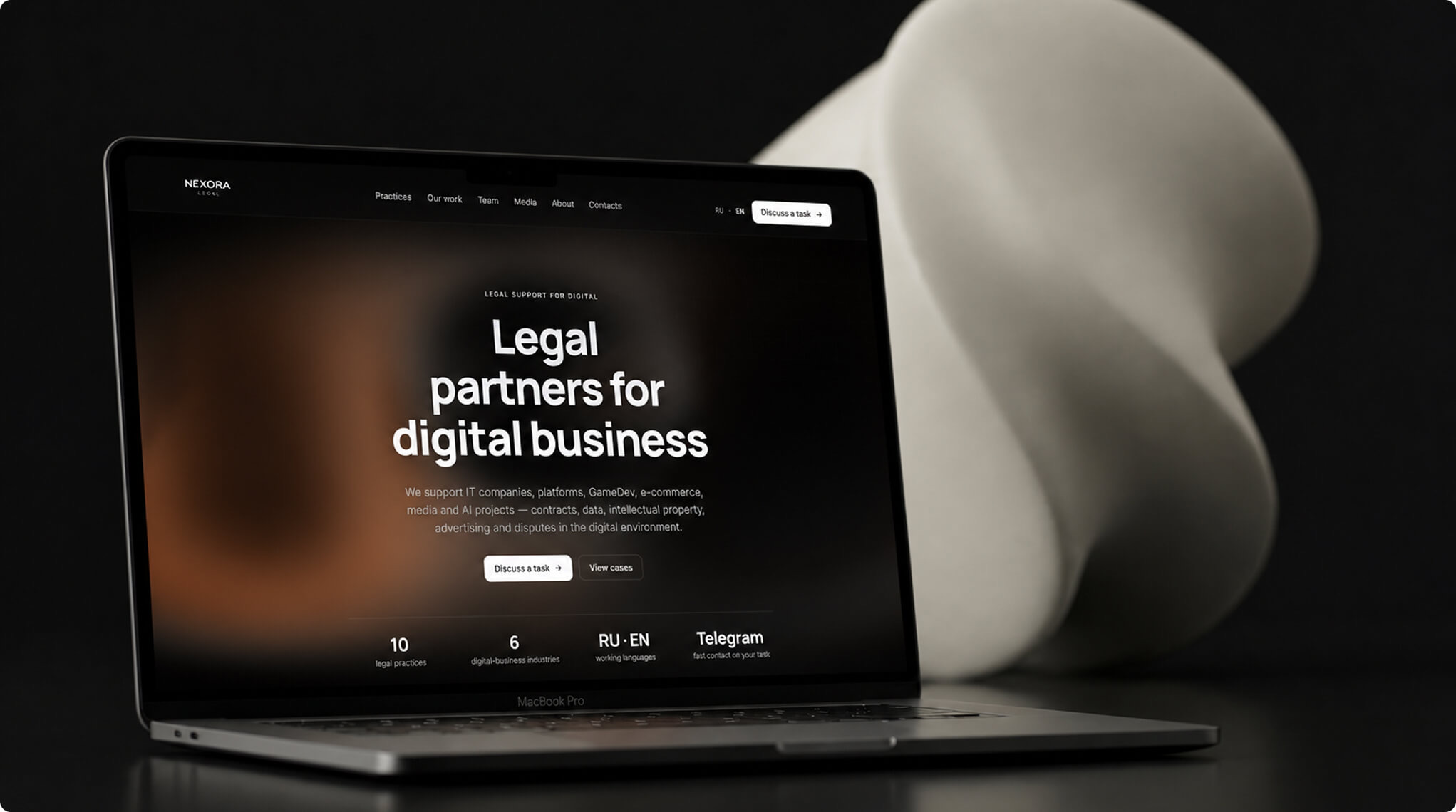 Nexora Legal: dark v2 site on a MacBook